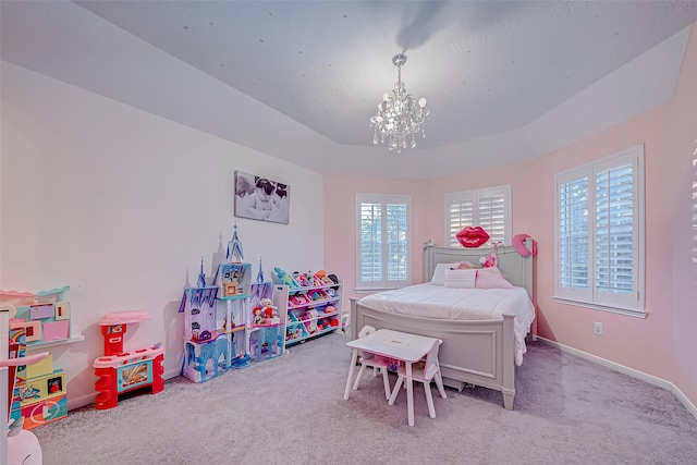 bedroom featuring multiple windows, light carpet, a raised ceiling, and a chandelier