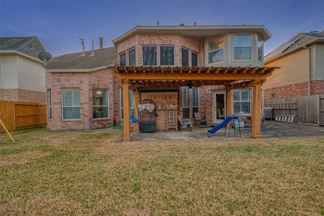 rear view of house with a patio, a yard, and a pergola