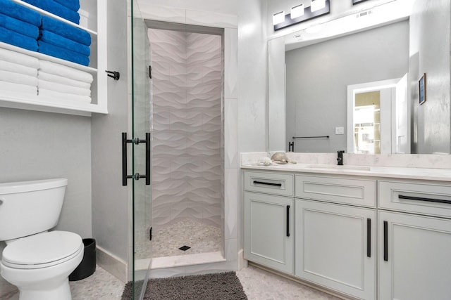 bathroom with toilet, walk in shower, and vanity