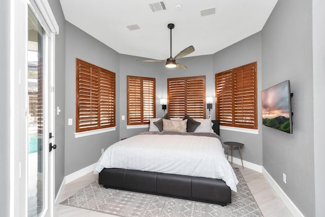 bedroom featuring access to exterior, ceiling fan, and light wood-type flooring