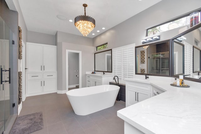 bathroom featuring vanity, tile patterned floors, a notable chandelier, and plus walk in shower