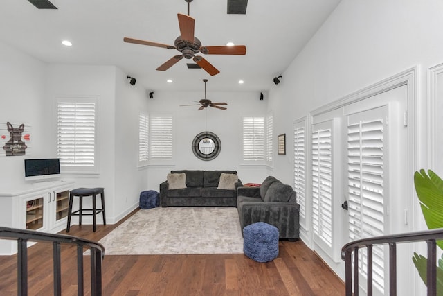 living room with hardwood / wood-style flooring and ceiling fan