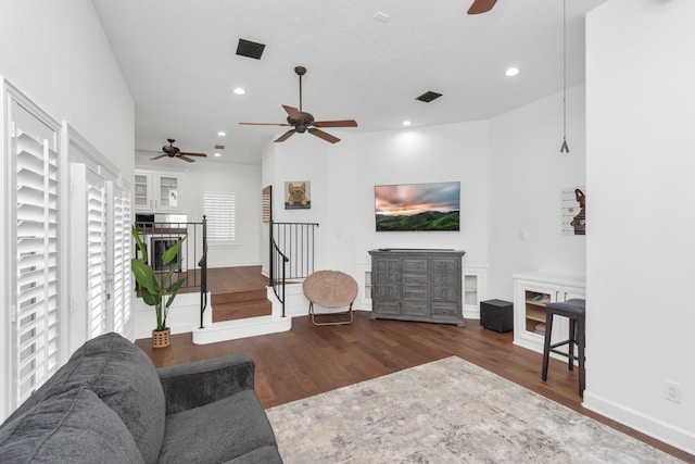 living room featuring dark hardwood / wood-style flooring and ceiling fan