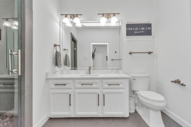 bathroom featuring vanity, a shower with door, tile patterned flooring, and toilet