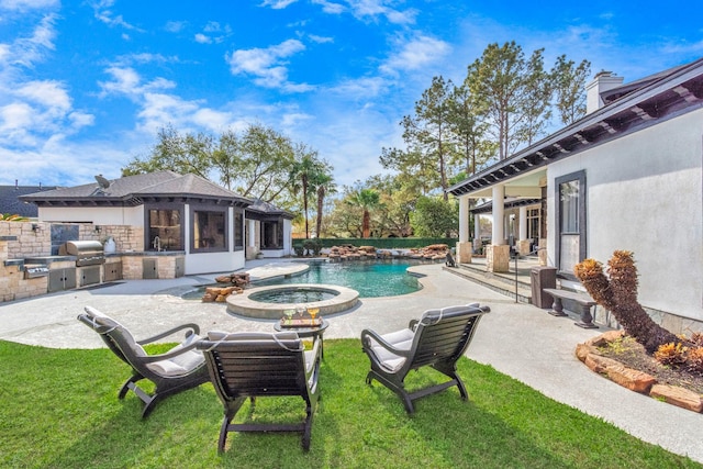 view of pool featuring grilling area, an outdoor kitchen, an in ground hot tub, and a patio area