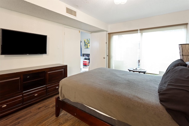 bedroom with dark hardwood / wood-style flooring