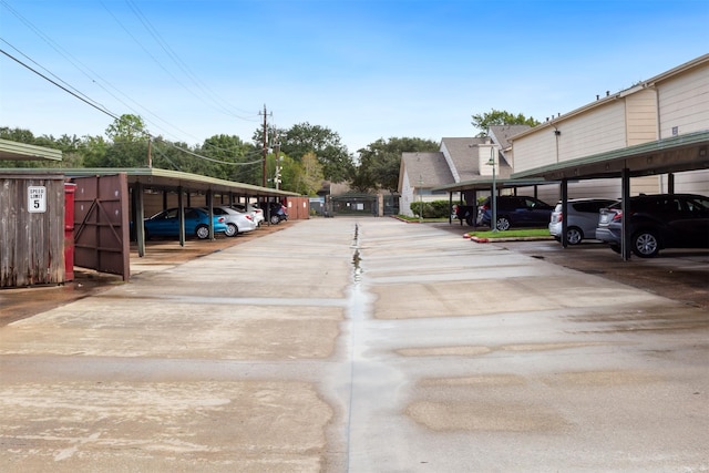 view of parking / parking lot featuring a carport