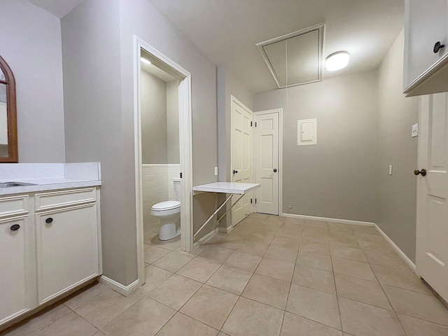 bathroom featuring toilet, vanity, and tile patterned flooring