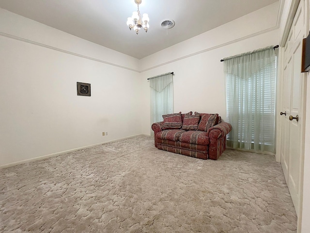 living room with carpet and a notable chandelier