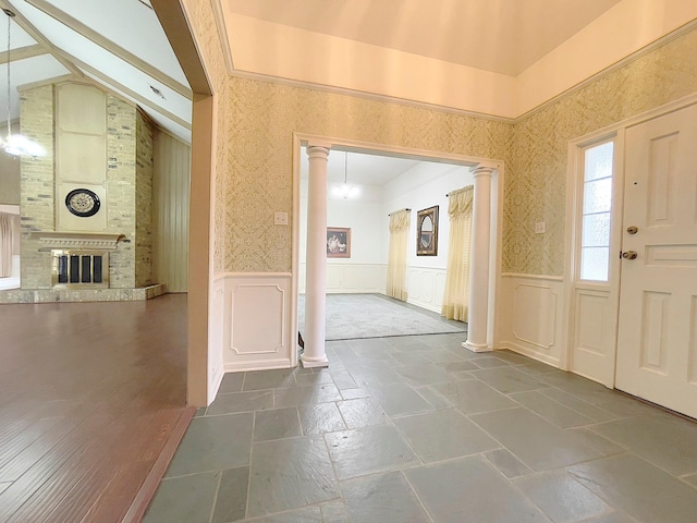 entryway with a fireplace and ornate columns