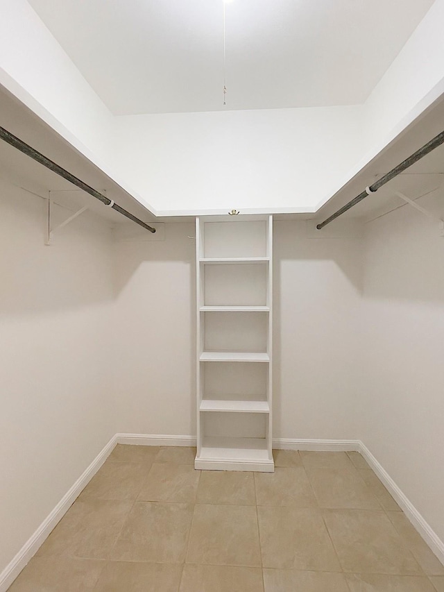 spacious closet with tile patterned floors