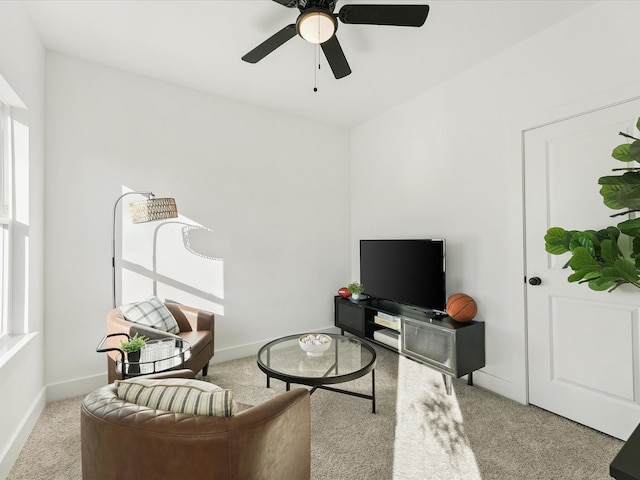 living room featuring light colored carpet and ceiling fan