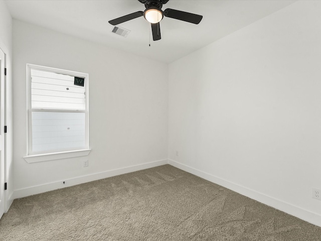 spare room with ceiling fan and carpet