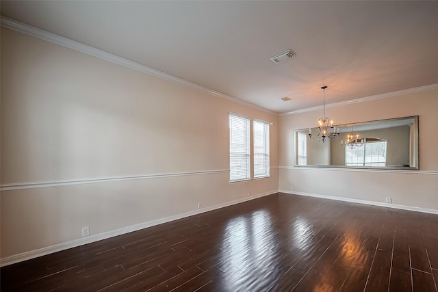 empty room with visible vents, an inviting chandelier, dark wood-style floors, and a healthy amount of sunlight