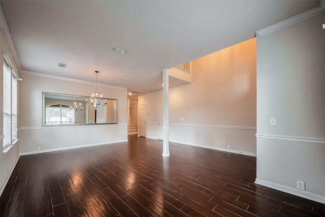 unfurnished living room with an inviting chandelier, wood finished floors, and visible vents