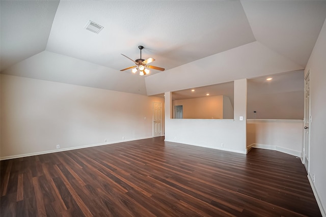 unfurnished room with dark wood-style floors, visible vents, ceiling fan, and vaulted ceiling