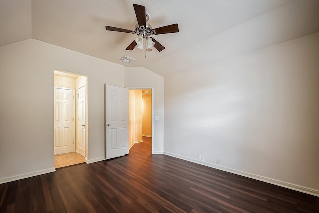 unfurnished bedroom featuring visible vents, dark wood-style floors, baseboards, ceiling fan, and vaulted ceiling