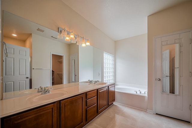 bathroom with tile patterned flooring, double vanity, a bath, and a sink