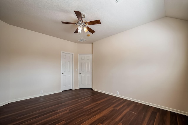 spare room with visible vents, dark wood-type flooring, baseboards, ceiling fan, and a textured ceiling