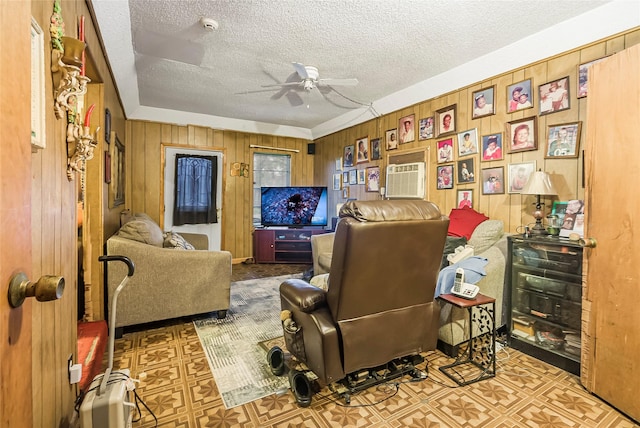 office area featuring ceiling fan, wooden walls, and a textured ceiling