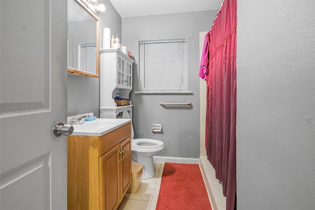 bathroom with curtained shower, toilet, tile patterned flooring, and vanity