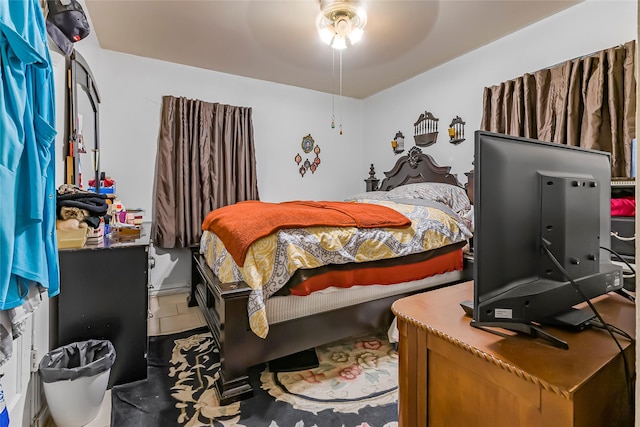 bedroom featuring ceiling fan and tile patterned flooring