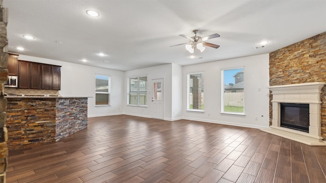 unfurnished living room with ceiling fan