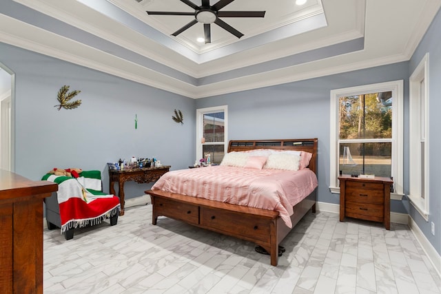 bedroom featuring ceiling fan, a tray ceiling, and ornamental molding