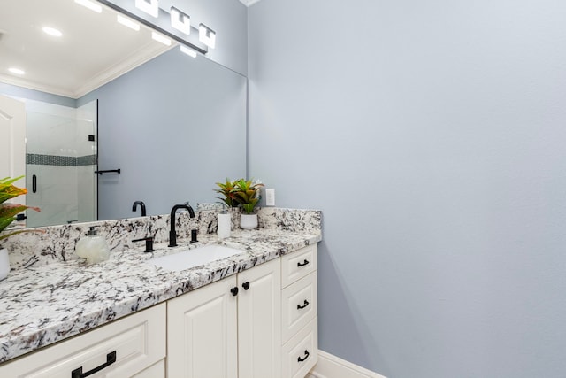 bathroom with an enclosed shower, vanity, and ornamental molding