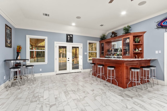 bar with ceiling fan and french doors