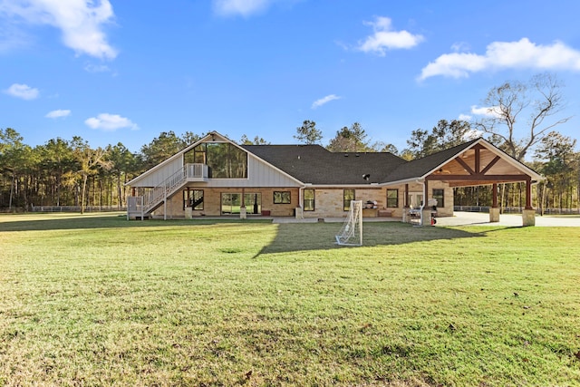 rear view of property featuring a lawn