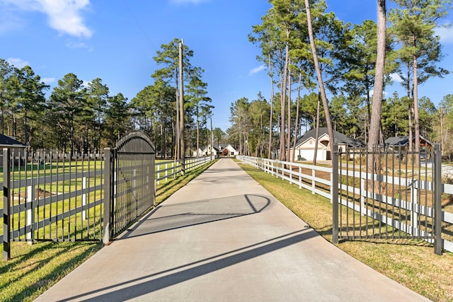 view of gate featuring a lawn