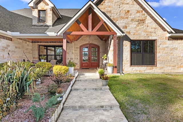 entrance to property with a lawn and french doors