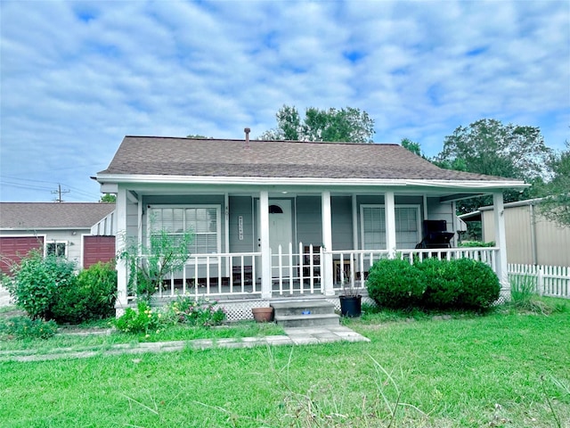 back of house with a porch and a yard