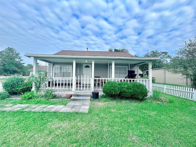 view of front of property with a porch and a front lawn