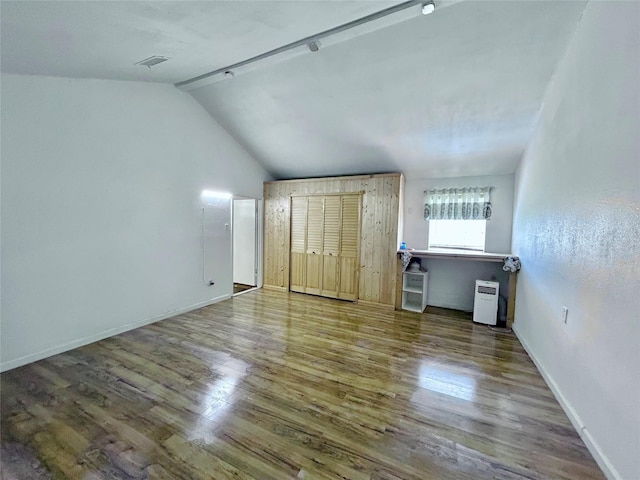 interior space with lofted ceiling and hardwood / wood-style flooring