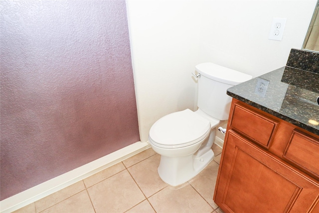 bathroom featuring tile patterned flooring, vanity, and toilet