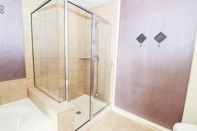 bathroom featuring tile patterned flooring and independent shower and bath