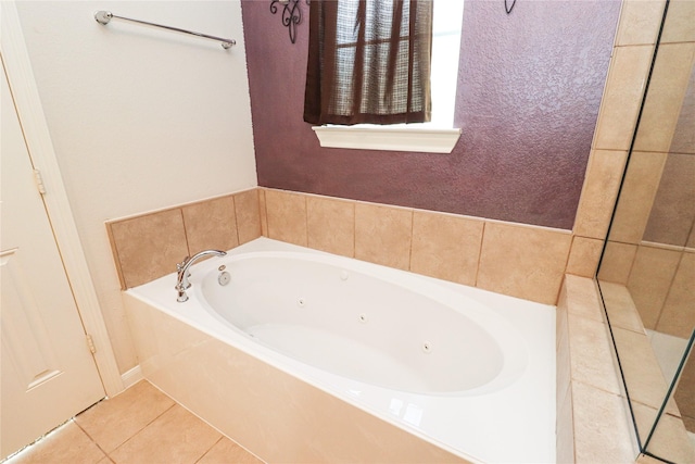 bathroom with tile patterned flooring and a tub