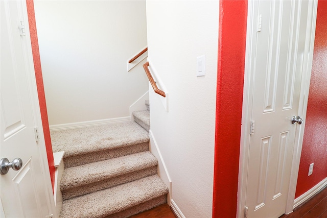 stairway featuring wood-type flooring