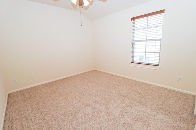 empty room featuring carpet, ceiling fan, and vaulted ceiling