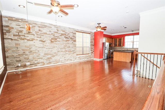 unfurnished living room with ceiling fan, crown molding, dark hardwood / wood-style flooring, and sink