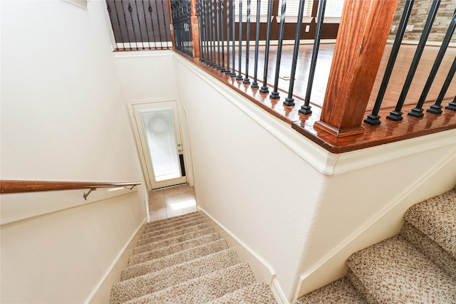 staircase featuring tile patterned floors