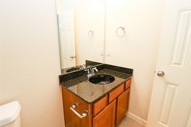 bathroom featuring toilet and vanity