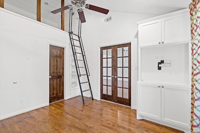 entrance foyer featuring french doors, high vaulted ceiling, light wood-type flooring, and ceiling fan