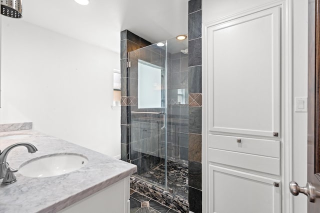 bathroom with vanity and a shower with shower door