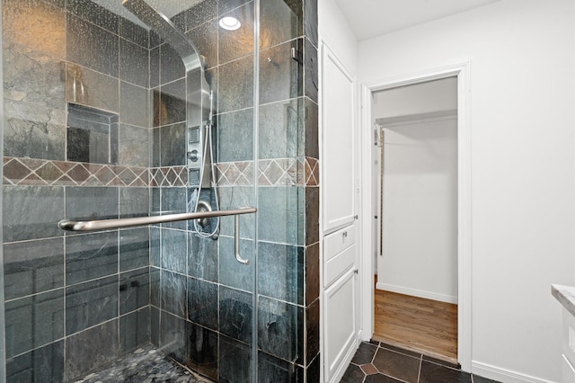 bathroom with walk in shower and tile patterned floors