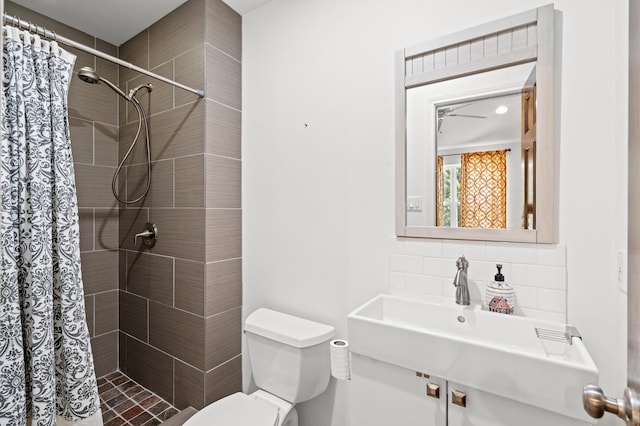 bathroom with toilet, walk in shower, decorative backsplash, and sink