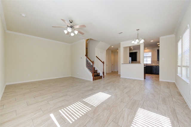 unfurnished living room with ceiling fan with notable chandelier and ornamental molding