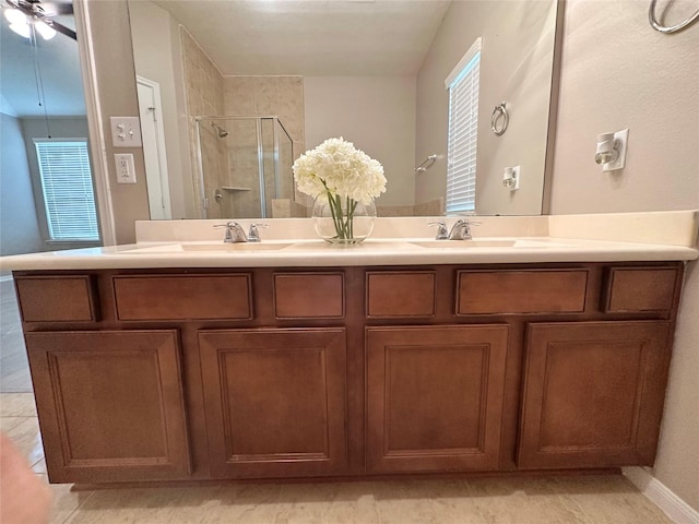 bathroom with vanity, ceiling fan, tile patterned flooring, and a shower with door